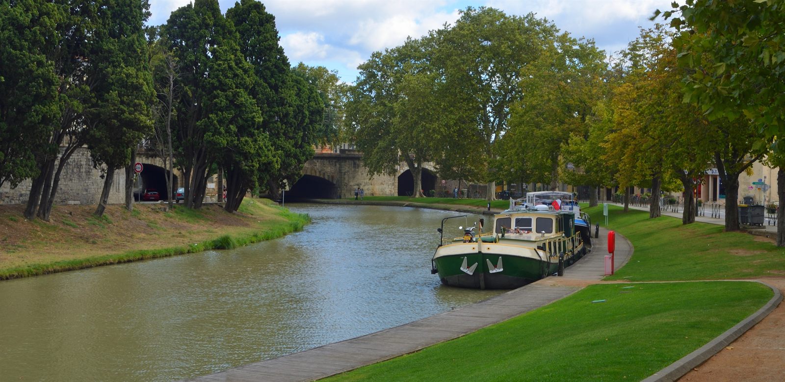 Canal barge moored under plane trees near Carcassonne, France